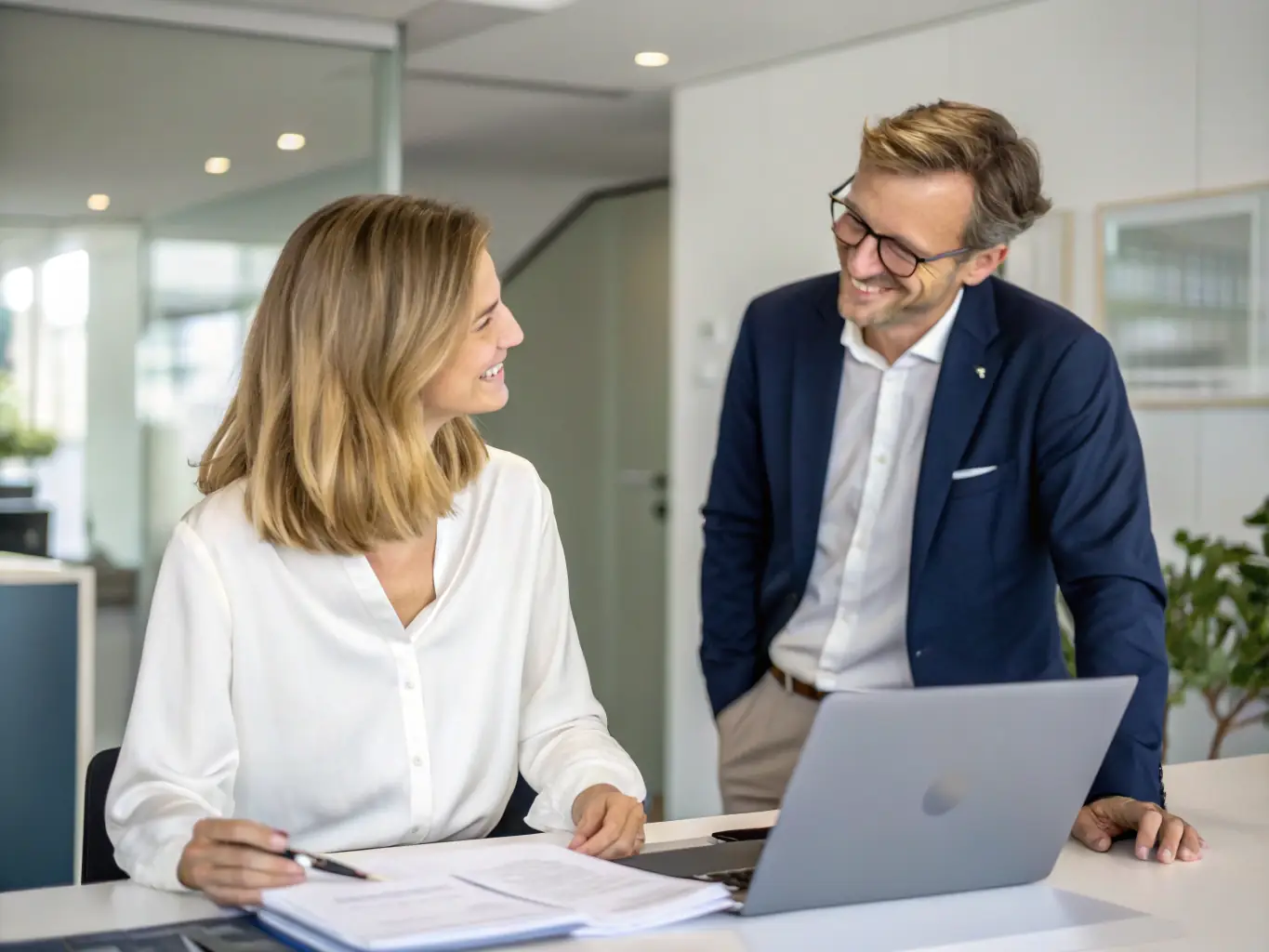 A photo of a property manager reviewing financial reports and discussing performance metrics with a property owner.